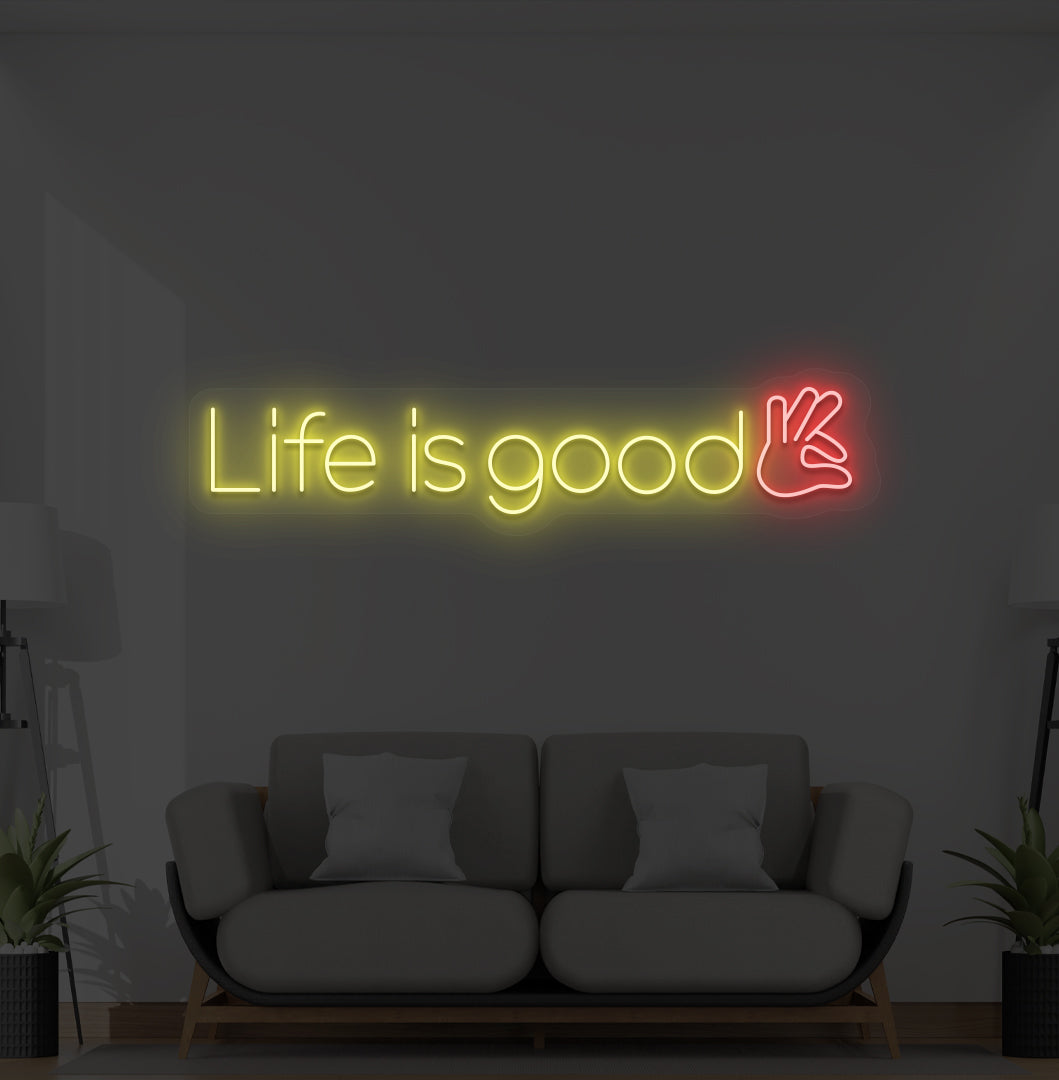 Aesthetic wall with "life is good" neon sign glowing yellow.