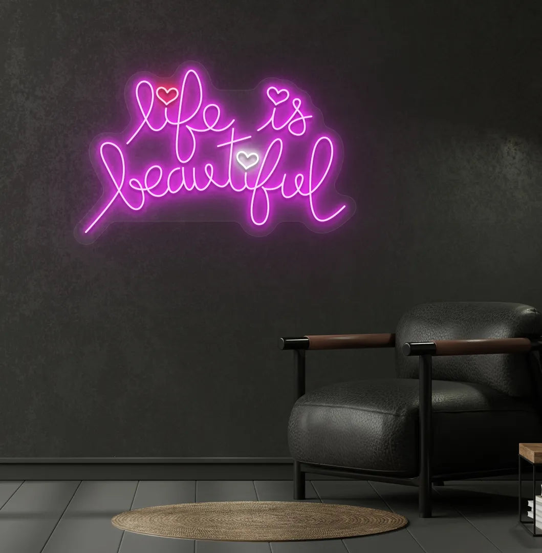 Inspirational Life Is Beautiful neon sign glowing pink on aesthetic wall.