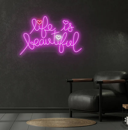 Inspirational Life Is Beautiful neon sign glowing pink on aesthetic wall.