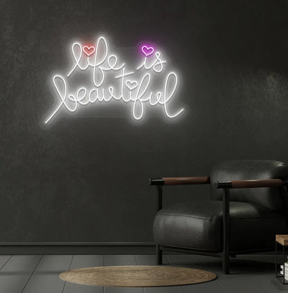 Inspirational Life Is Beautiful neon sign glowing white on aesthetic wall.