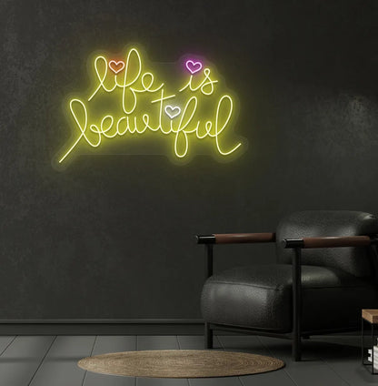 Trendy Life Is Beautiful neon sign mounted on aesthetic bedroom wall in yellow color.