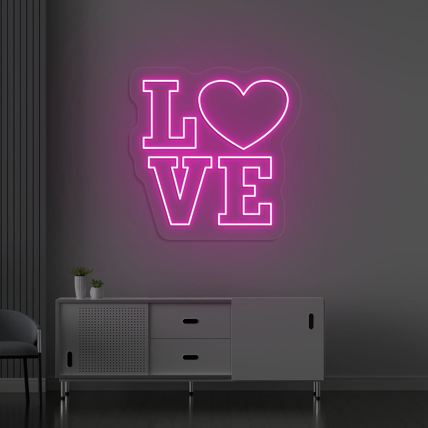 Image of a love neon sign glowing on a wall in pink color.