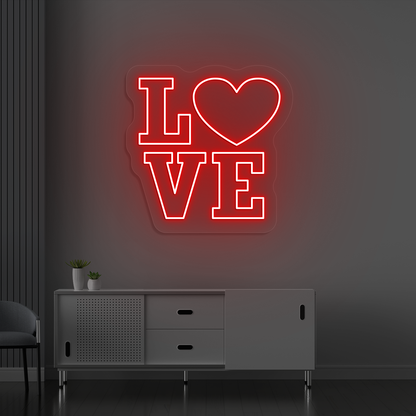 Image of a love neon sign glowing on a wall in red color.