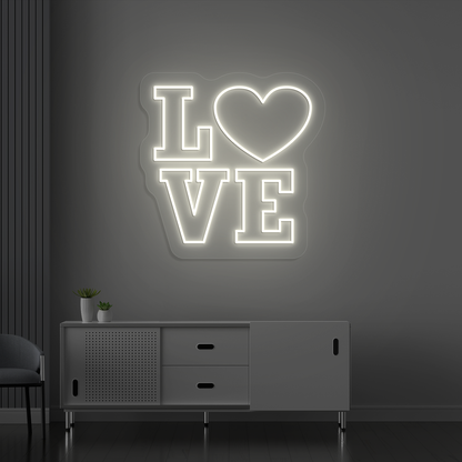 Romantic warm white LED love neon sign glowing on a wall.