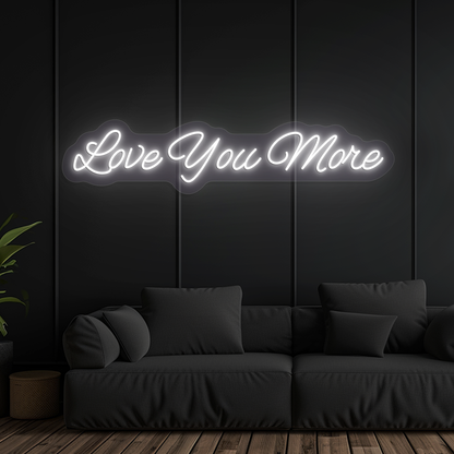Image of a "love you more" LED neon sign glowing on wall in white color.