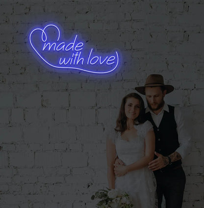 Image of a made with Love wedding neon sign mounted on aesthetic wall in blue color.