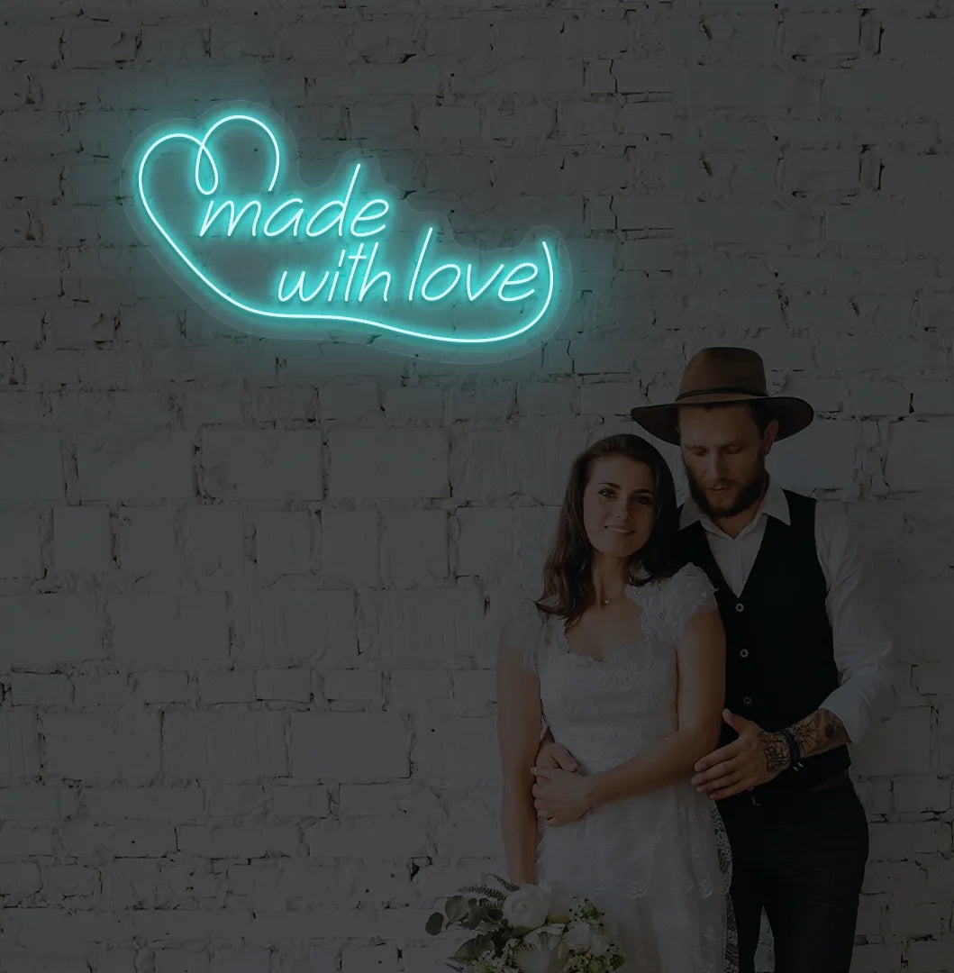 Image of a made with Love wedding neon sign mounted on aesthetic wall in ice blue color.