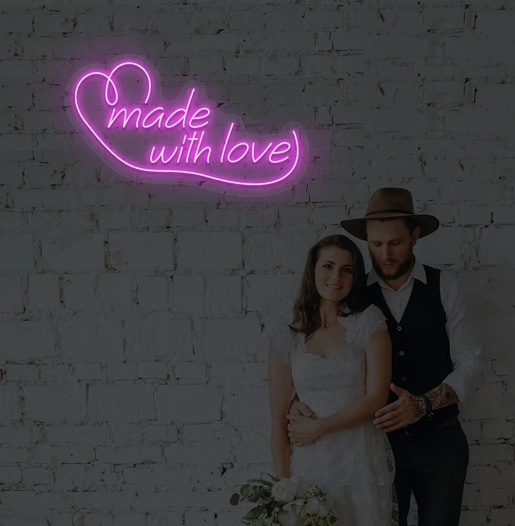 Image of a made with Love wedding neon sign mounted on aesthetic wall in pink color.