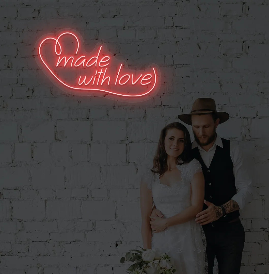 Image of a made with Love wedding neon sign mounted on aesthetic wall in red color.