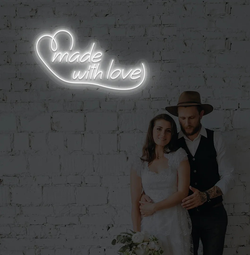 Image of a made with Love wedding neon sign mounted on aesthetic wall in white color.