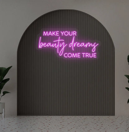 Image of a "Make your beauty dreams come true" neon sign in pink color on salon wall decor.