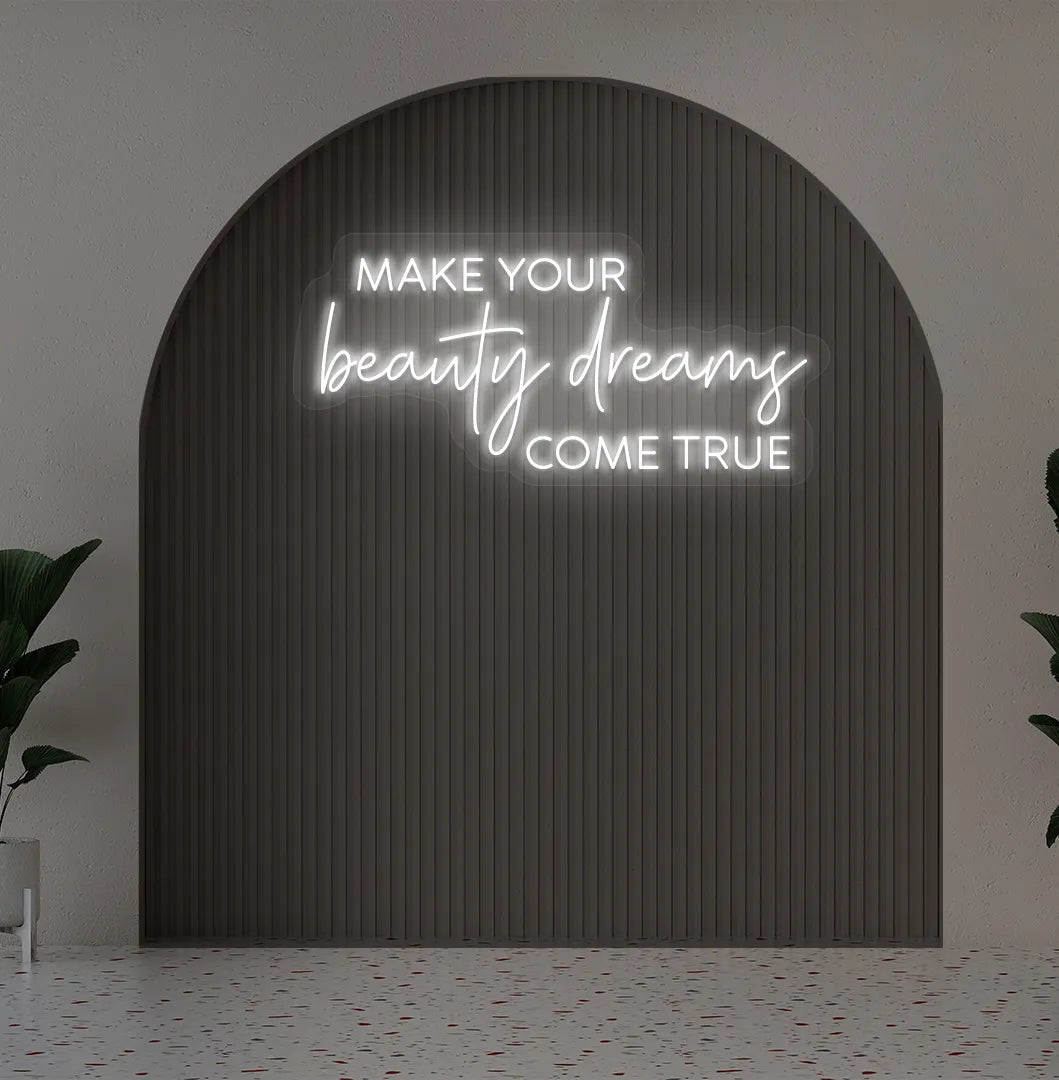Image of a "Make your beauty dreams come true" neon sign in white color on salon wall decor.