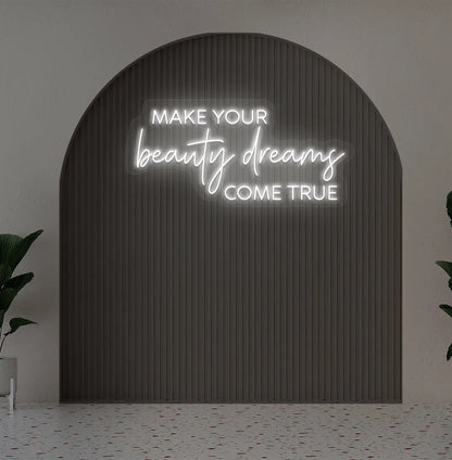 Image of a "Make your beauty dreams come true" neon sign in white color on salon wall decor.
