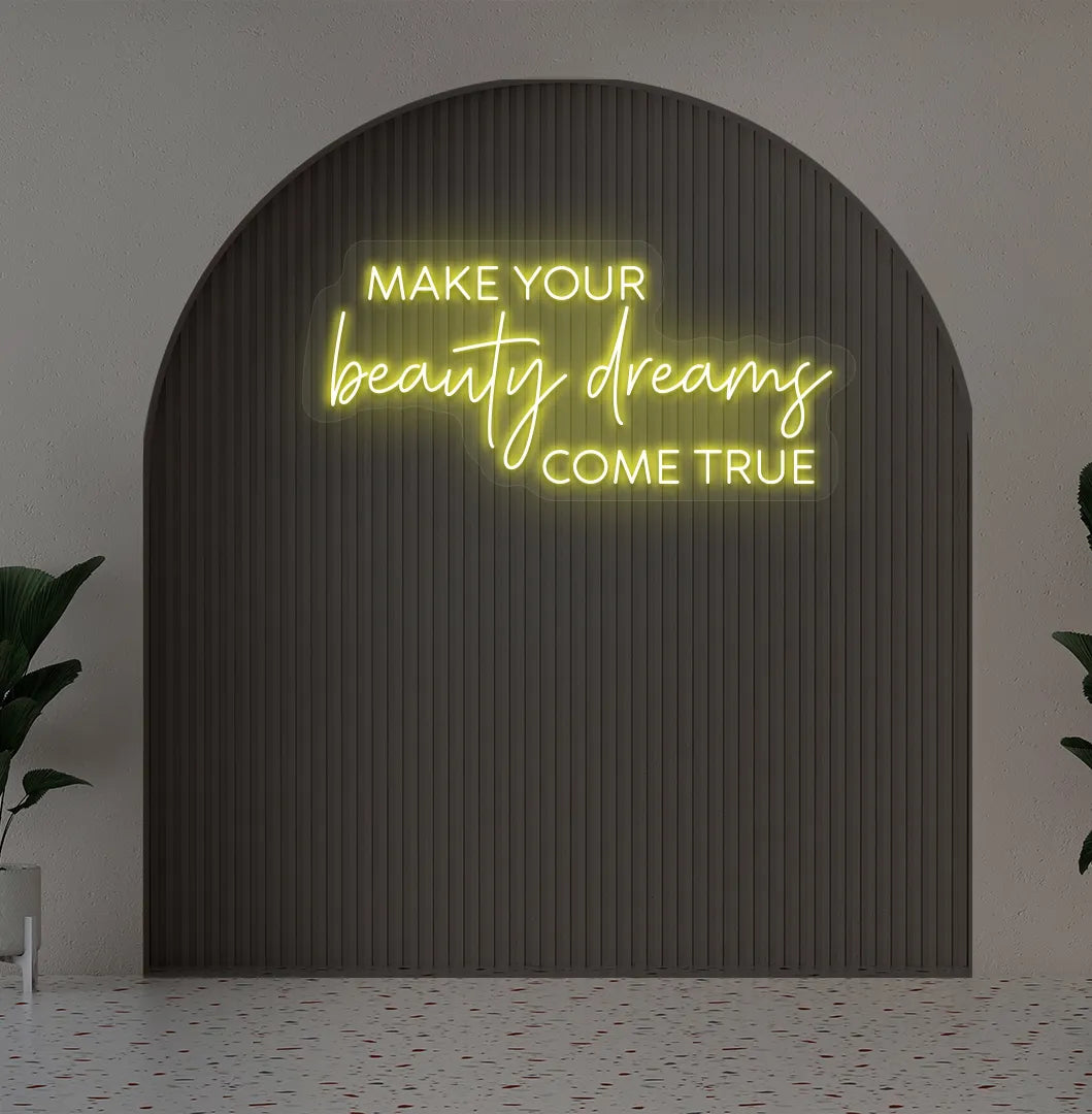 Yellow "make your beauty dreams come true" LED neon sign for beauty studio setup.