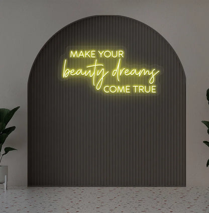 Yellow "make your beauty dreams come true" LED neon sign for beauty studio setup.
