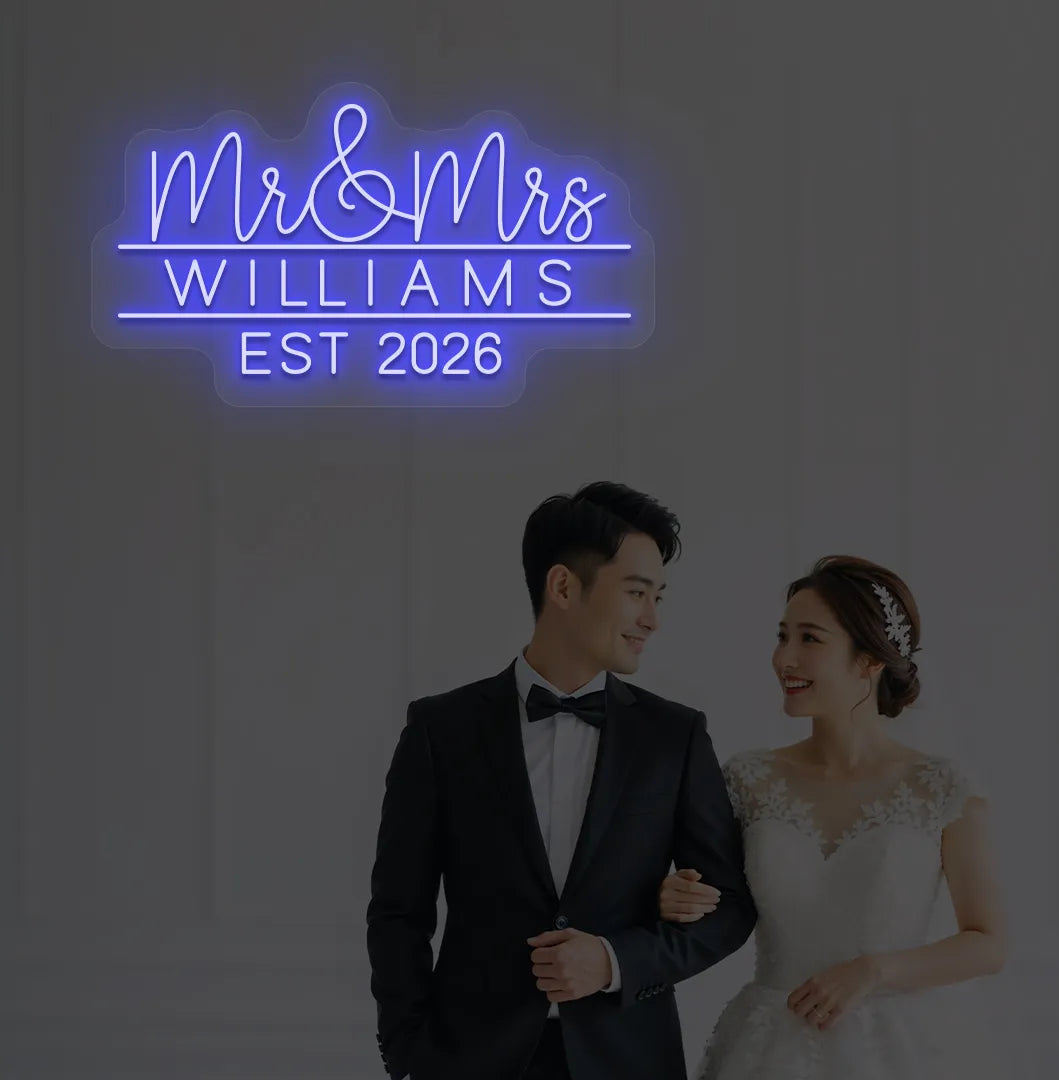 Personalized Mr and Mrs wedding neon sign glowing blue on wedding backdrop.