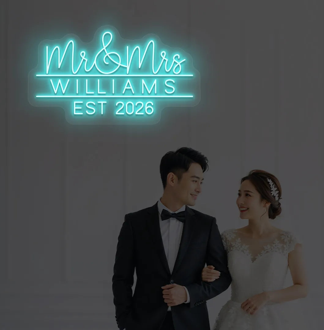 Personalized Mr and Mrs wedding neon sign glowing ice blue on wedding backdrop.
