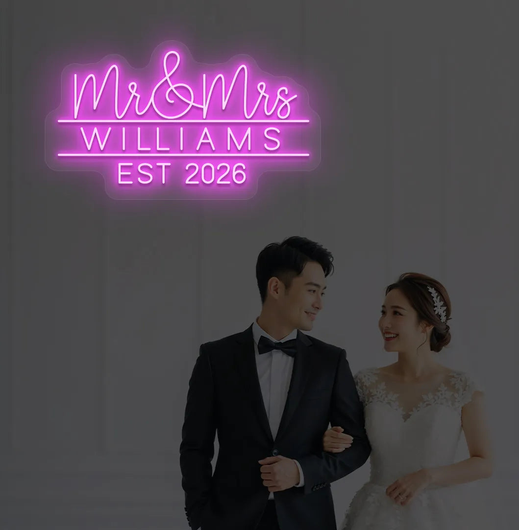 Personalized Mr and Mrs wedding neon sign glowing pink on wedding backdrop.