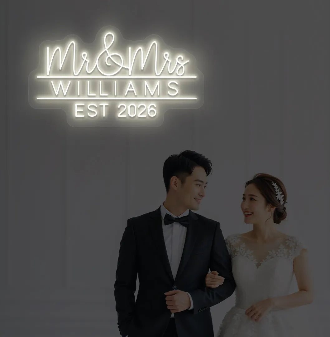 Warm white Mr and Mrs personalized wedding LED neon sign glowing on decorative wall.