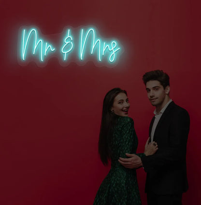 Image of a stylish Mr and Mrs wedding neon sign mounted on aesthetic wall in ice blue color.