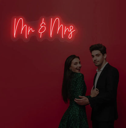 Image of a stylish Mr and Mrs wedding neon sign mounted on aesthetic wall in red color.