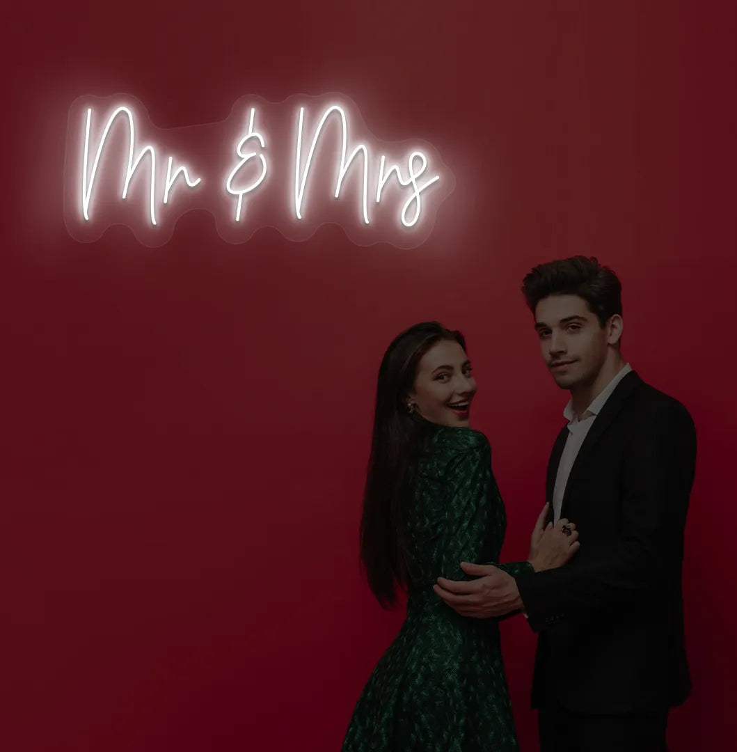 Image of a stylish Mr and Mrs wedding neon sign mounted on aesthetic wall in white color.