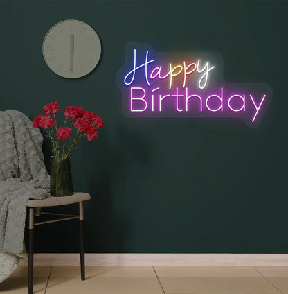 Image of a stylish multicolor Happy Birthday neon sign mounted on modern wall in pink color.