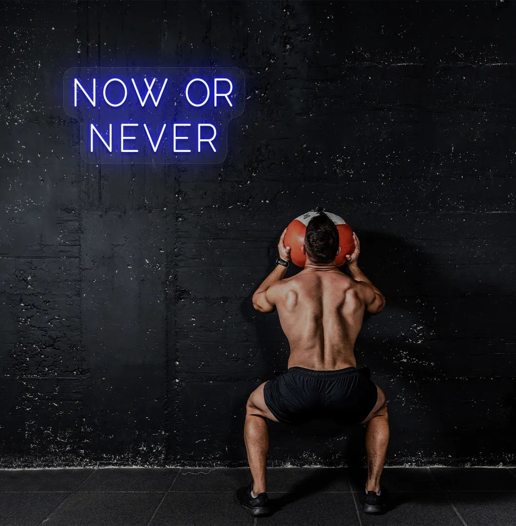 Image of a bright blue "now or never" neon sign for motivational gym decor.