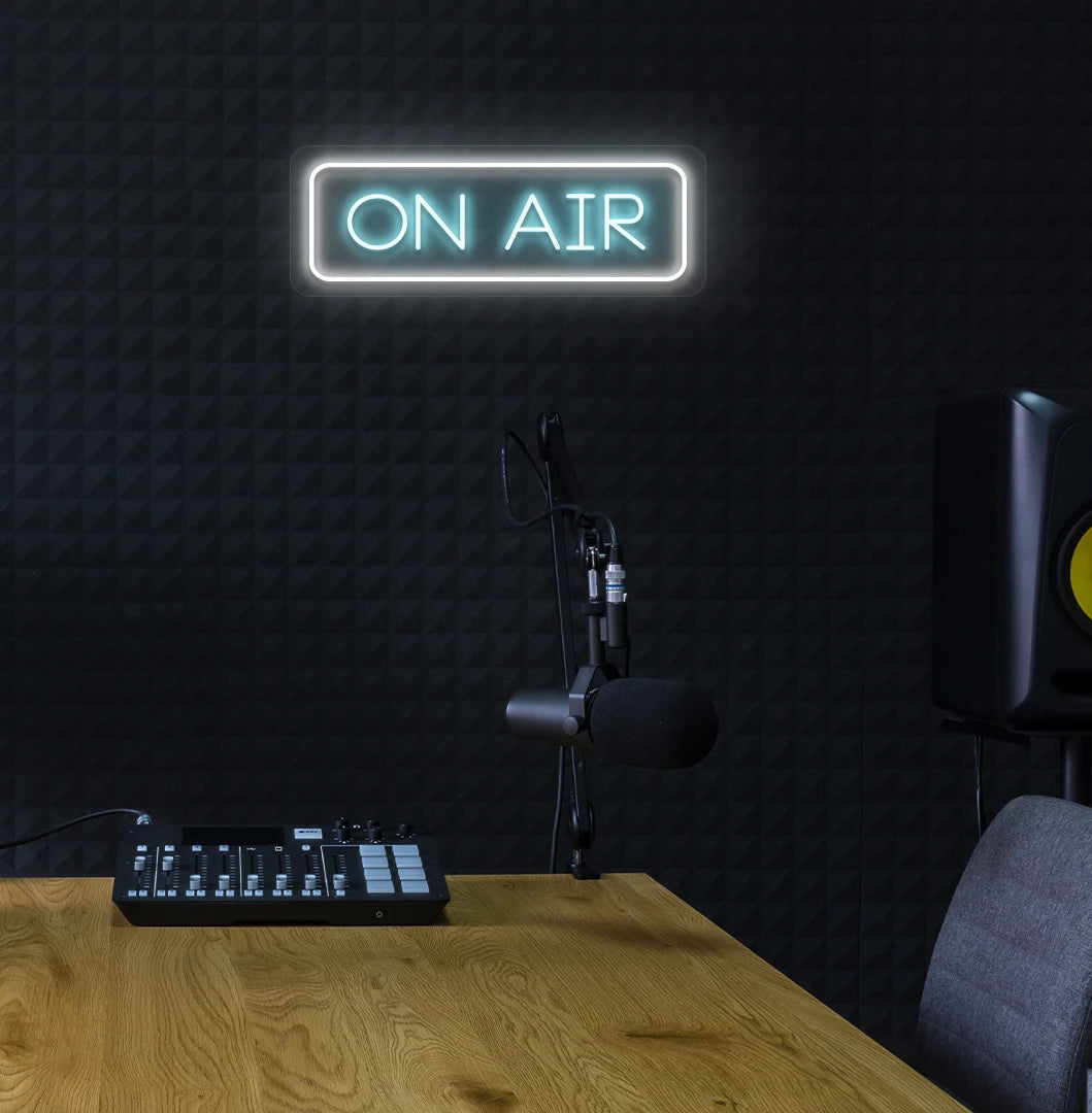Stylish ON Air neon sign in ice blue mounted on studio wall.