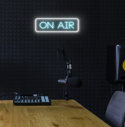 Stylish ON Air neon sign in ice blue mounted on studio wall.