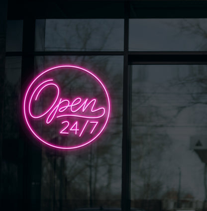 Image of a modern "open 24/7" LED neon sign glowing on wall in pink color.