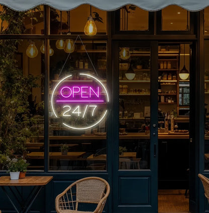 Modern cafe entrance with Open 24/7 neon sign glowing warm white.