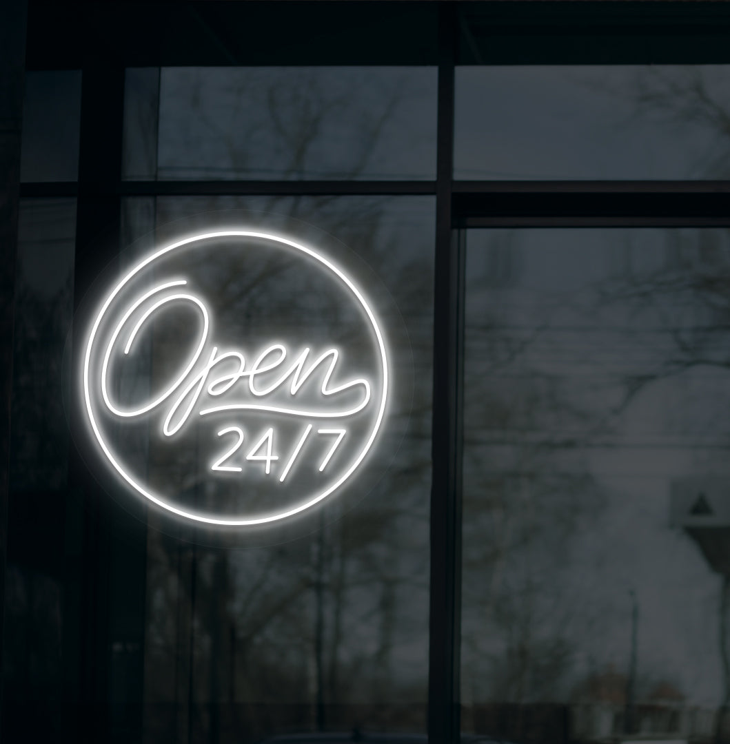 Image of a modern "open 24/7" LED neon sign glowing on wall in white color.