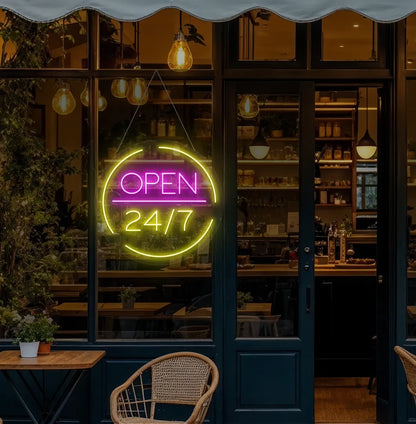 Modern cafe entrance with Open 24/7 neon sign glowing yellow.