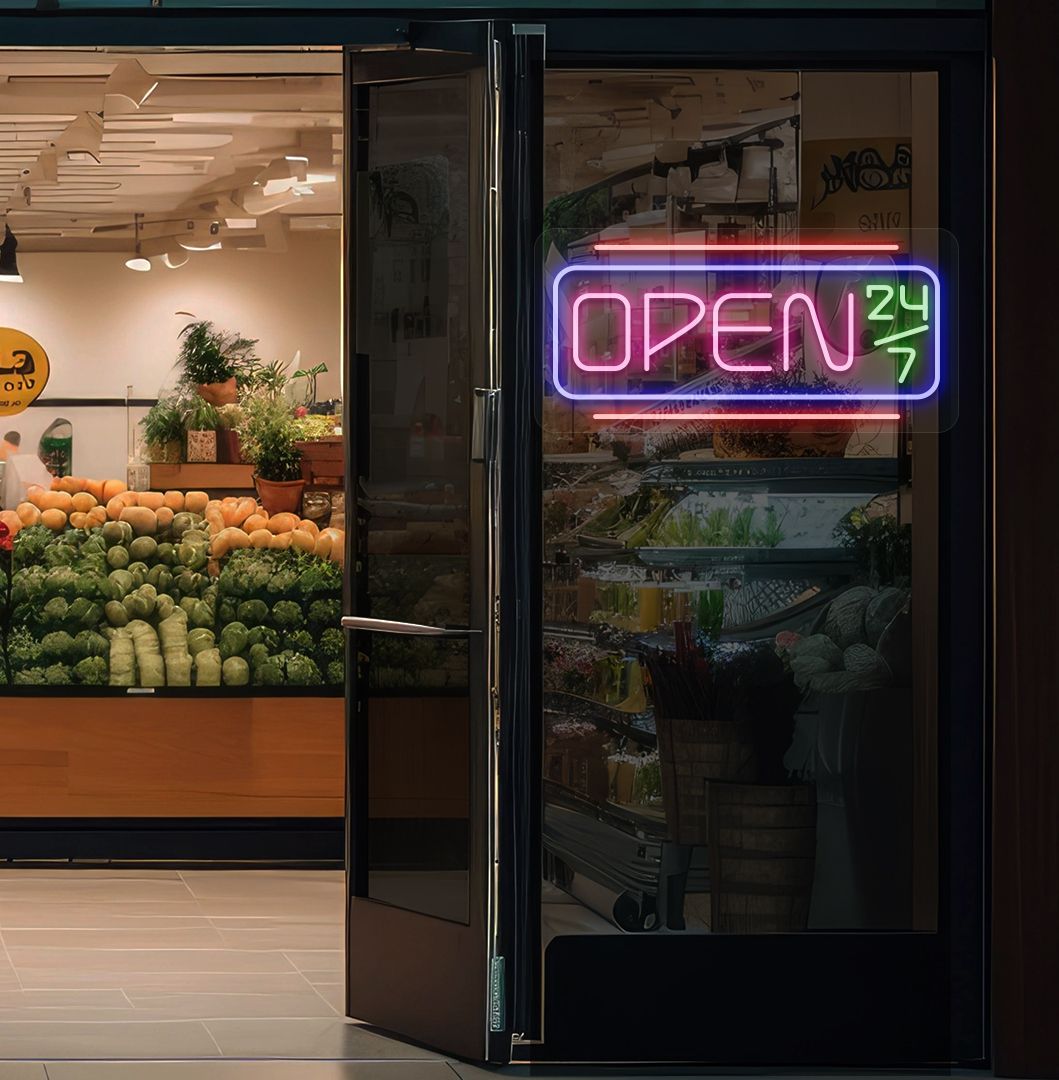 Image of an open 24/7 LED neon sign glowing on a store glass door in pink color.