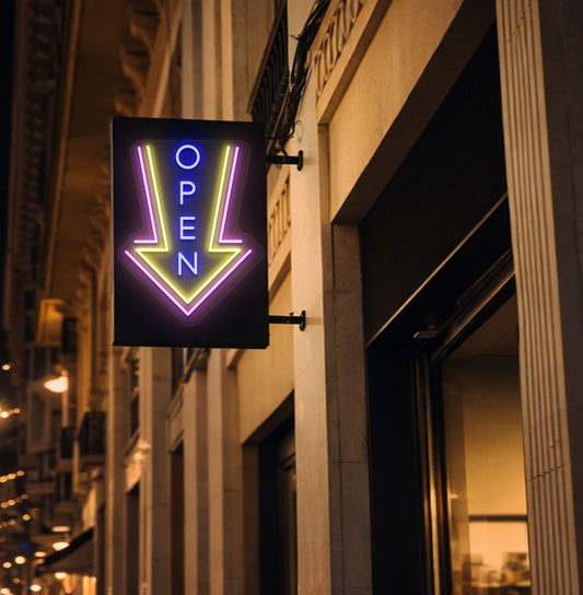 Image of an open arrow neon sign glowing on outdoor shop stand in blue color.
