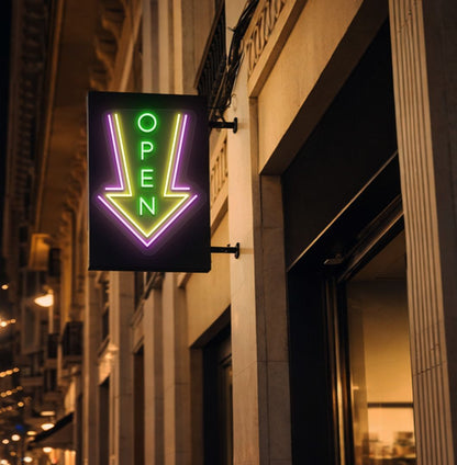 Directional open arrow neon sign glowing green on outdoor stand.