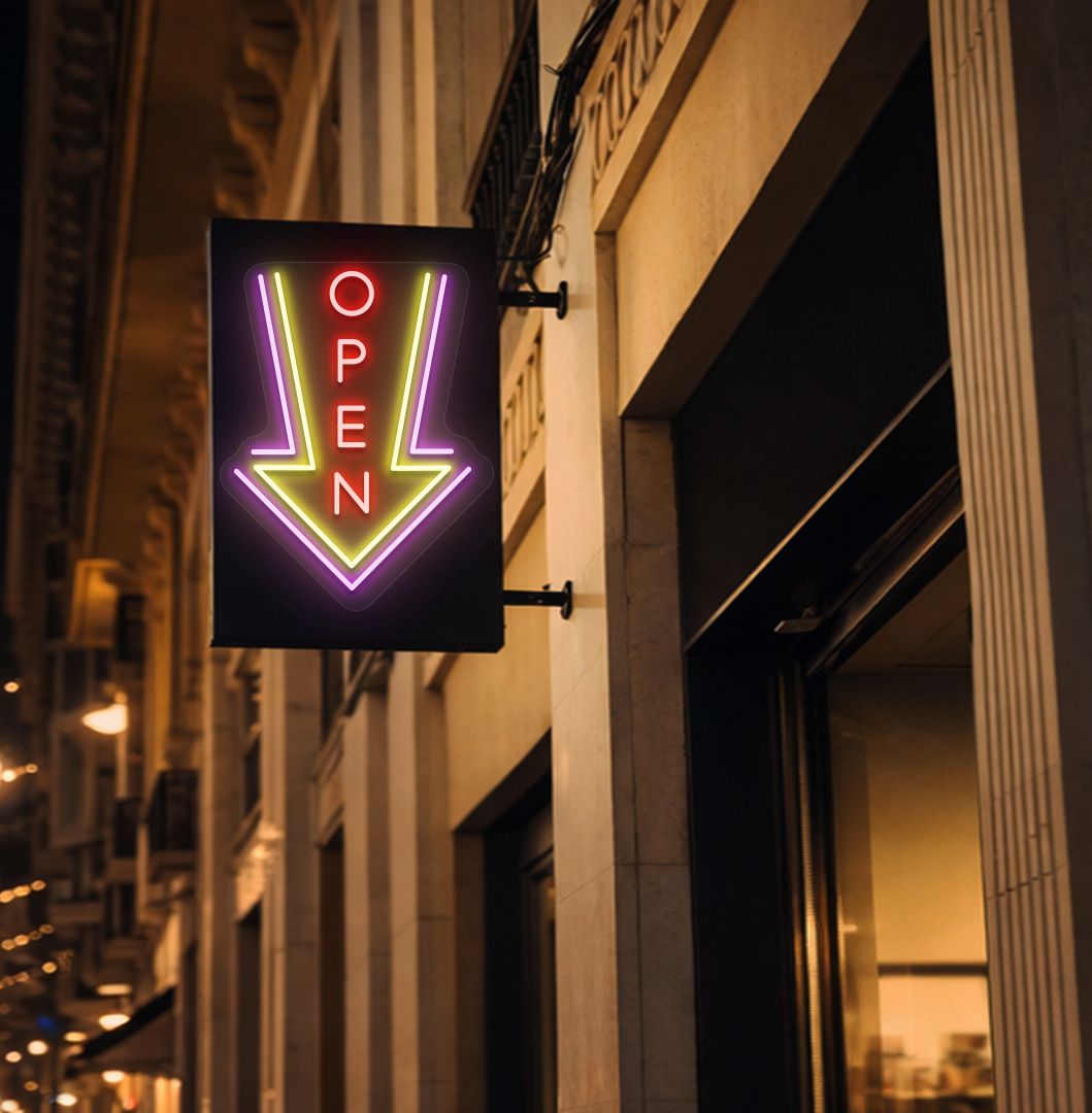 Image of an open arrow neon sign glowing on outdoor shop stand in red color.
