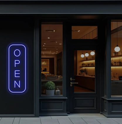 Image of an open LED neon sign glowing on a shop exterior wall in blue color.