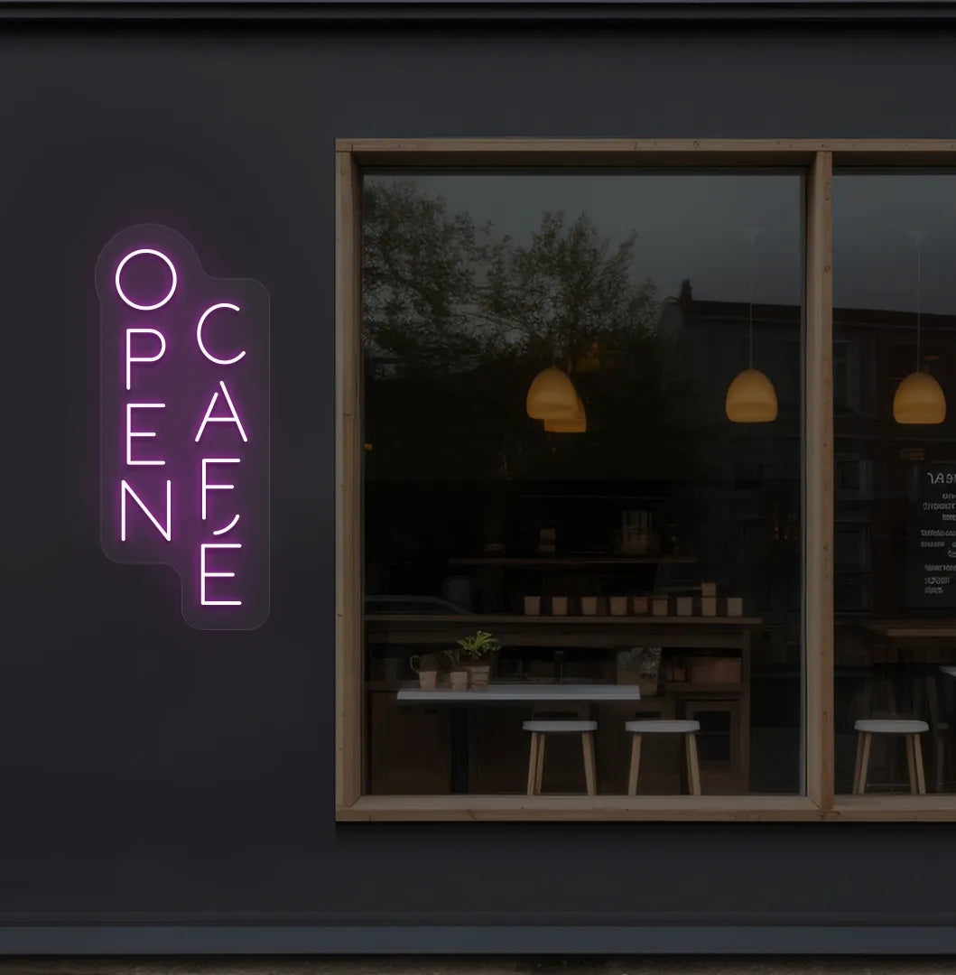 Trendy open cafe neon sign in pink mounted on coffee shop wall.