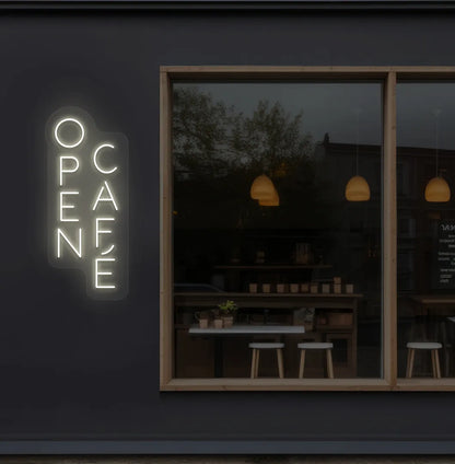 Trendy open cafe neon sign in warm white mounted on coffee shop wall.