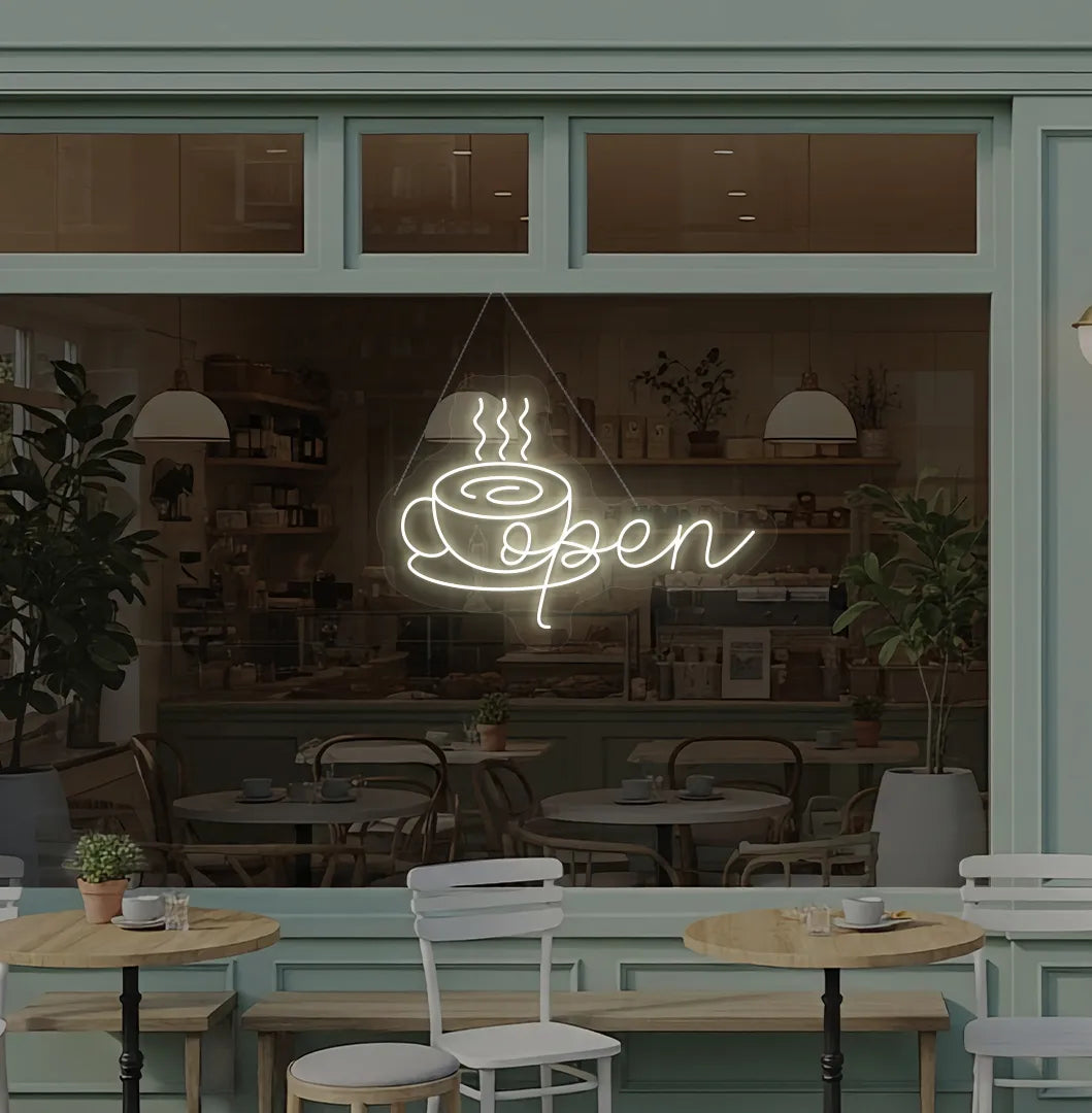 Modern cafe wall with open with coffee cup neon sign glowing warm white.