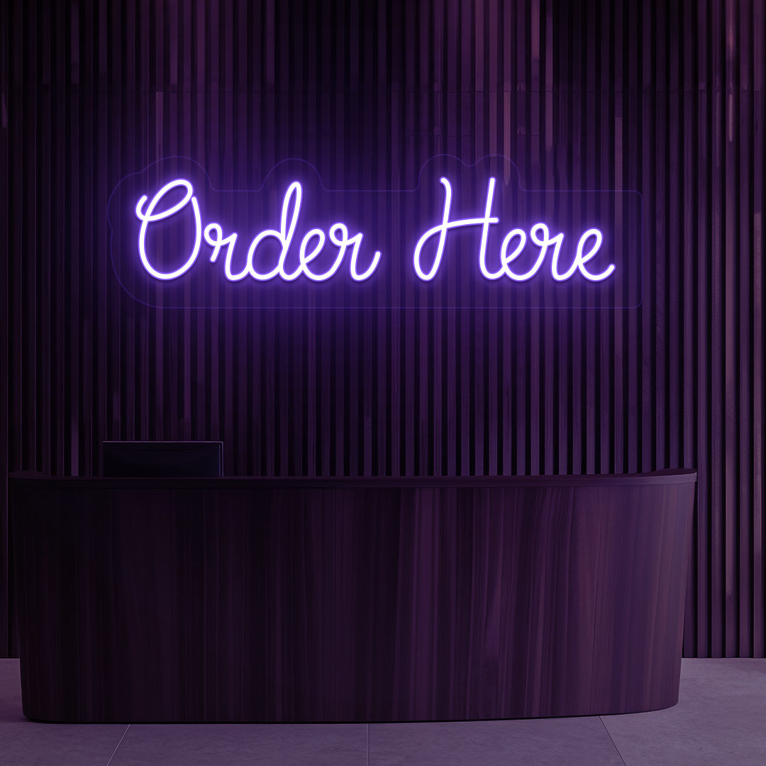 A bright purple "order now" neon sign is hanging on the cafe's wooden wall. Perfect for cafés, restaurants, food counters, and retail service counters.