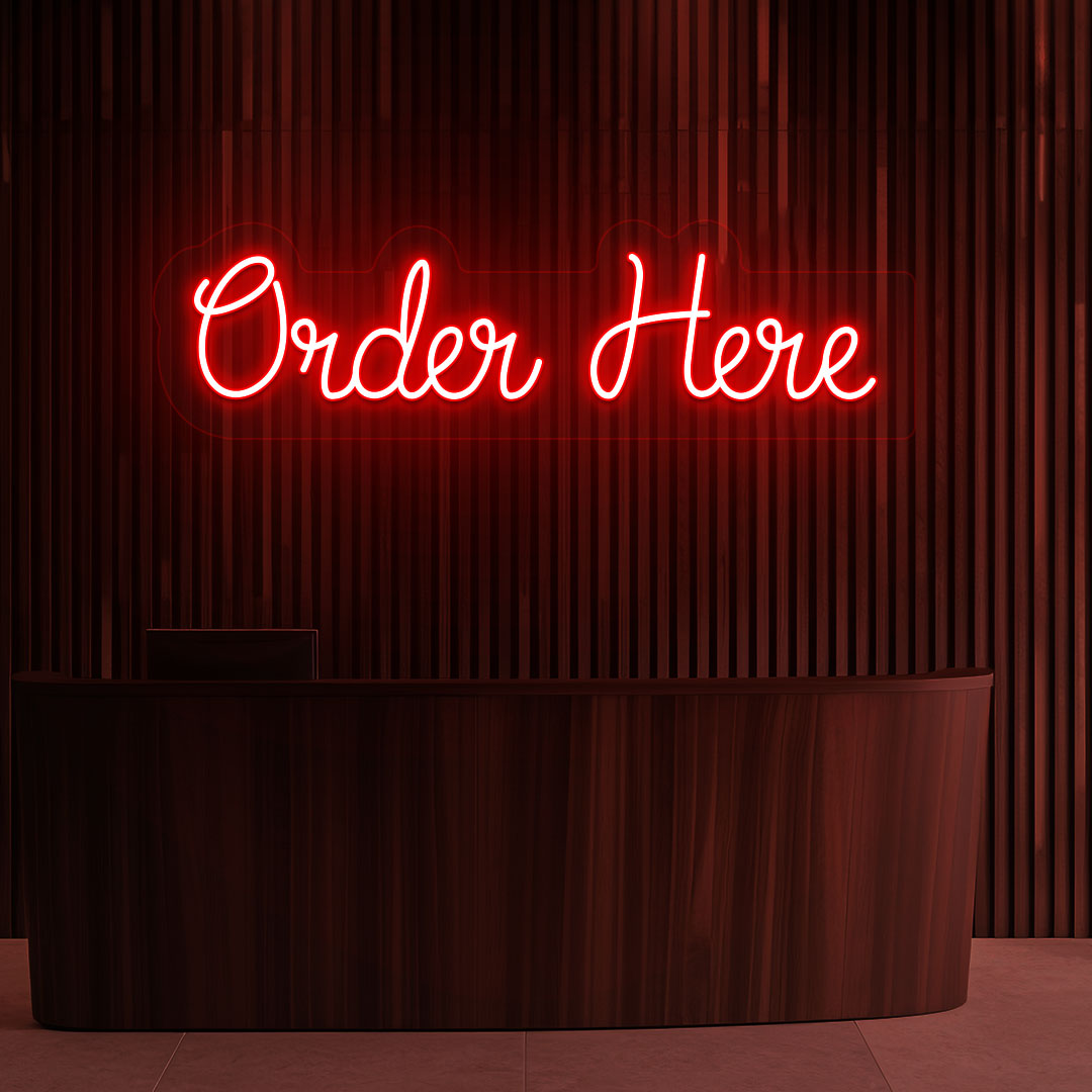 Image of a neon sign that says "order now" glowing in red color on a wooden wall above the counter in a cafe.