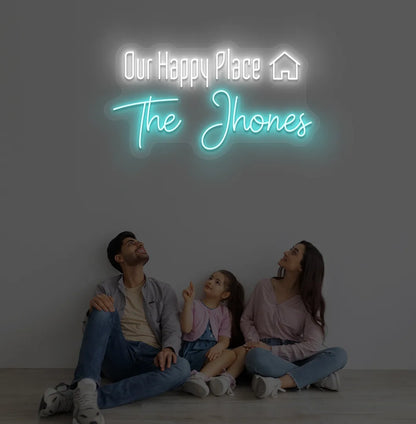 Personalized Our Happy Place custom name neon sign in ice blue color mounted on modern wall.