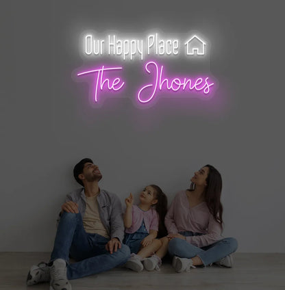 Personalized Our Happy Place custom name neon sign in pink color mounted on modern wall.