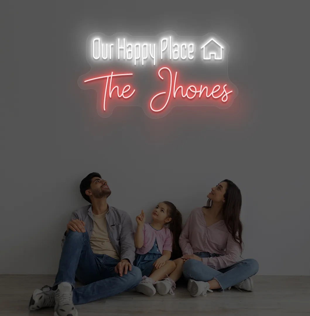 Personalized Our Happy Place custom name neon sign in red color mounted on modern wall.