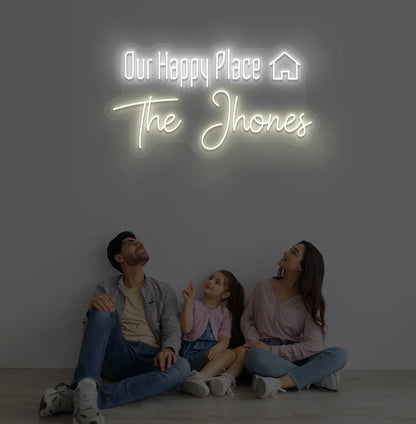 Bright warm white Our Happy Place personalized name neon sign for home decoration.