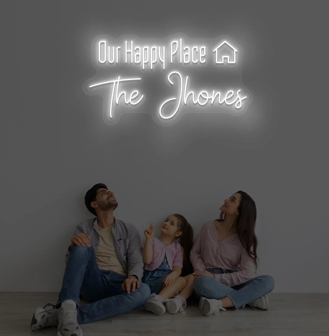 Personalized Our Happy Place custom name neon sign in white color mounted on modern wall.