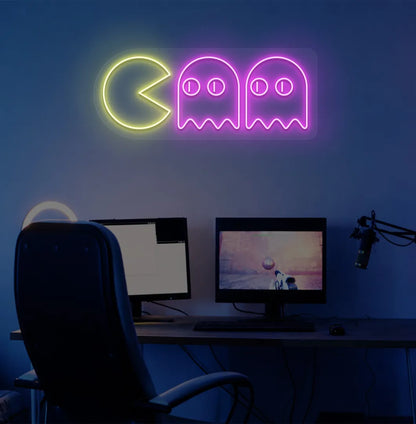 Image of a retro arcade Pacman neon sign mounted on gamer room wall in pink color.